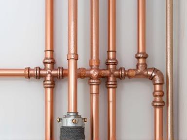 New copper pipes being installed during a repiping project.